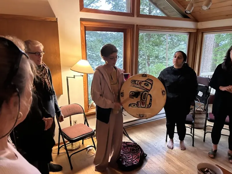 Indigenous land defender Rainbow Eyes teaching the group a welcome song